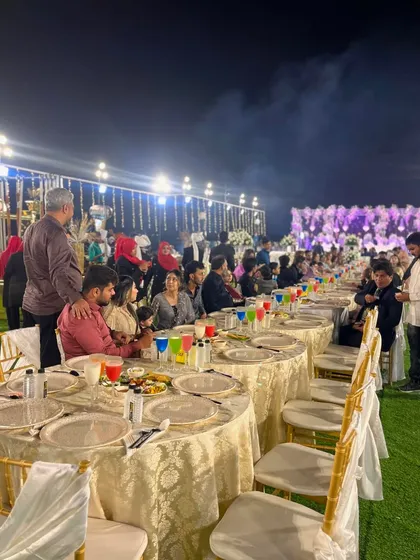 Guests seated at the long dining tables, enjoying the food and the wonderful ambiance of the event.