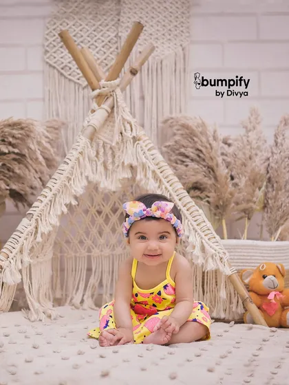 A happy baby in our boho teepee studio setup. This theme is perfect for capturing a child's playful and adventurous spirit in a stylish, modern way.