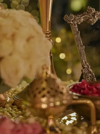 Another angle of the vintage decor elements, showing the interplay of textures between the brass, silver, and fresh flowers. Every detail is thoughtfully placed to create a beautiful composition.
