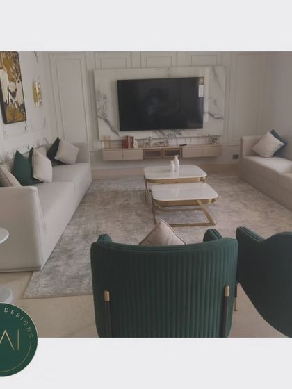 Another angle of the grand living room, showing the relationship between the seating areas and the marble-clad media wall. Our furniture is designed to complement and enhance the architectural features of a space.