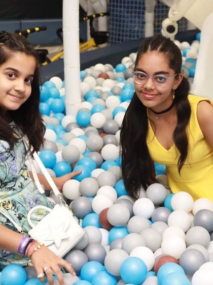 Friends enjoying the ball pit together. It's a wonderful place for social interaction, where kids can share laughs and create their own games.