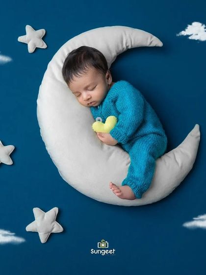Cuddling a little star while sleeping on the moon. It's these small, sweet details that make our themed newborn portraits so special and cherished.