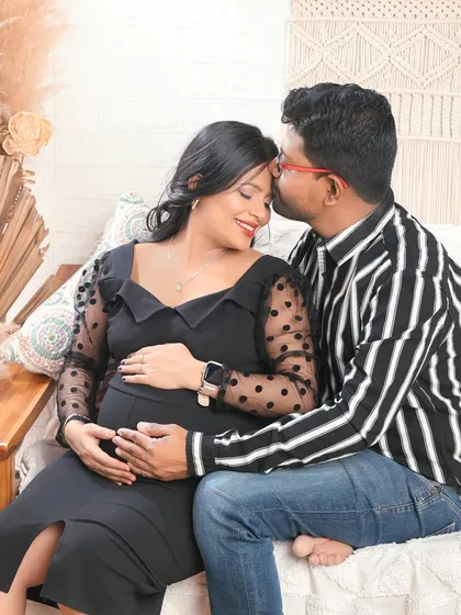 Set against a cozy boho backdrop, this image captures a sweet, intimate moment. It shows how we can create a warm and relaxed atmosphere for your couple's maternity shoot.