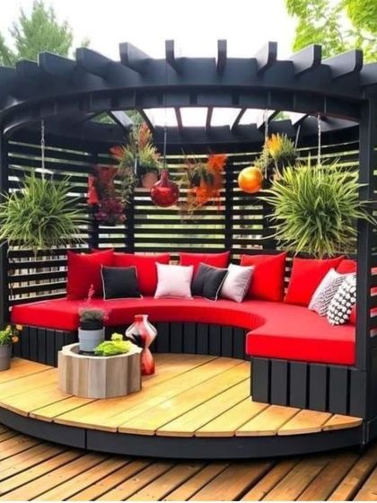 This unique circular pergola with a built-in curved sofa demonstrates our ability to execute custom designs. The vibrant red cushions add a pop of color to the wooden deck.