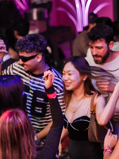A guest dancing with friends. The energy is always high, and the dance floor is always full.
