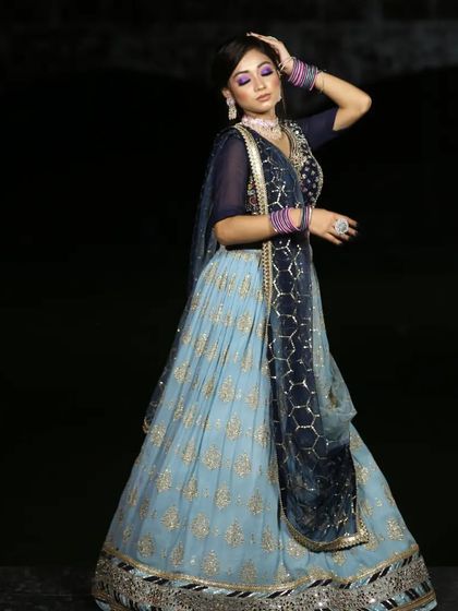 A serene and elegant light blue lehenga with gold work. This is a perfect choice for a daytime engagement or a summer wedding.