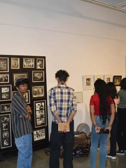 Students from ICAT Design & Media College looking at a display of vintage film stills and posters from 'Southern Stars'.