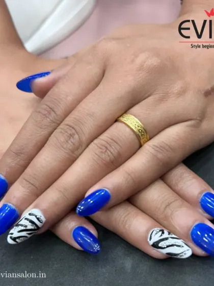 Show off your bold side with a design like this. I used a vibrant royal blue gel polish on almond-shaped nails and added hand-painted black and white zebra print accent nails to create a fun, high-contrast style.