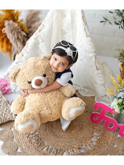 This little diva is rocking her fourth birthday session. The giant teddy bear and cool sunglasses add so much fun and personality to her photos.