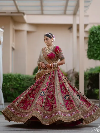 The perfect lehenga twirl. The volume and intricate work of this Marwar Couture creation are on full display in this classic bridal shot.