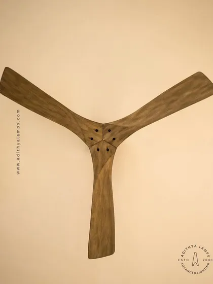 This designer ceiling fan showcases our commitment to craftsmanship and natural materials. The sculpted wooden blades offer a rustic yet modern aesthetic, turning a functional appliance into a central piece of decor. It represents our collection of remote-controlled fans that combine style with convenience.