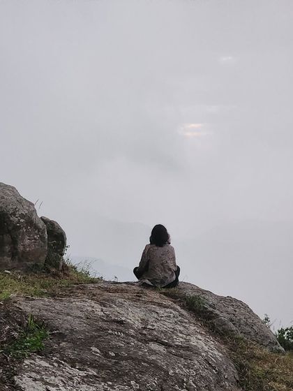 Finding solitude on a rocky outcrop, looking out over the misty Yercaud valley. Our trips provide space for both group fun and personal reflection.