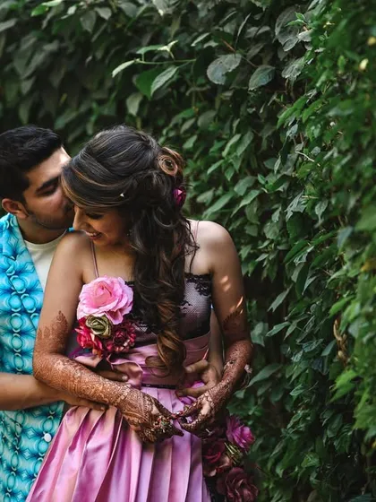 A romantic and intimate moment from a pre-wedding shoot, with the groom whispering to his bride.