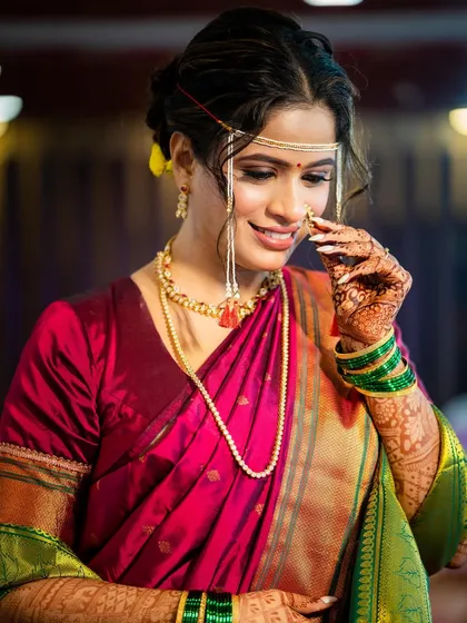 A close-up on the delicate details. The traditional *nath* is the star, and the makeup is kept clean and elegant to let it shine.