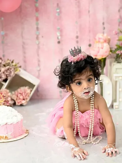 The pure, messy joy of a first birthday cake smash! This little princess is having the time of her life exploring her first taste of cake. These sessions are all about capturing candid happiness and personality.