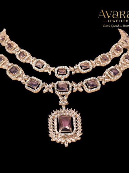 A beautiful layered necklace with amethyst-colored stones and zircons. This piece adds a touch of unique color and elegance to any outfit.