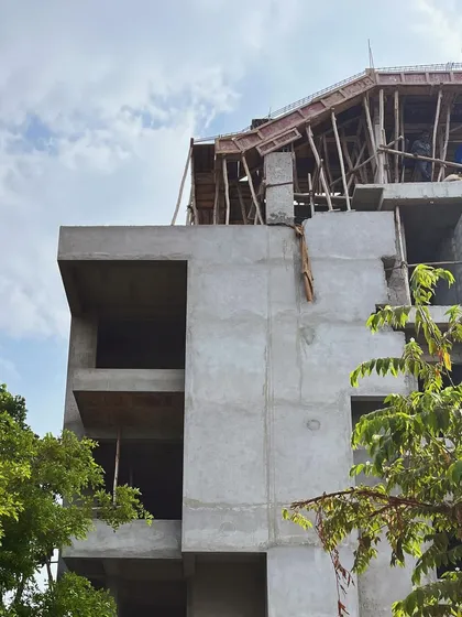 The upper levels of the building under construction, with wooden formwork in place for casting the concrete roof structure.