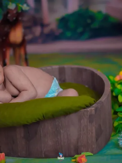 A whimsical jungle-themed setup for a newborn. The soft lighting and cute animal props create a magical forest atmosphere.