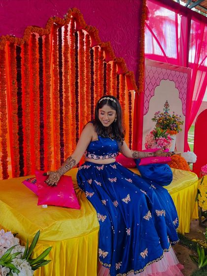 Supritha looking stunning in her blue lehenga at her mehendi function, with her arms adorned in my designs.