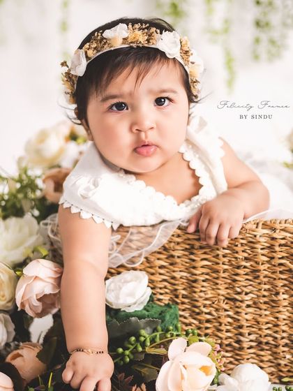 A basket full of joy and flowers. This sitter portrait combines a classic prop with a beautiful floral arrangement for a timeless and artistic feel.