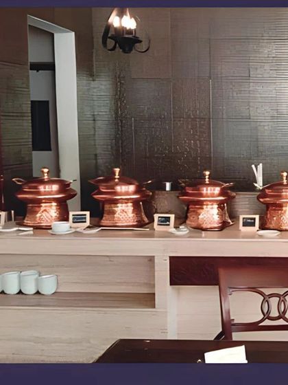 An indoor buffet arrangement showcasing our versatile copper pots. This setup is ideal for business meeting catering and office luncheons, offering a polished and organized presentation.