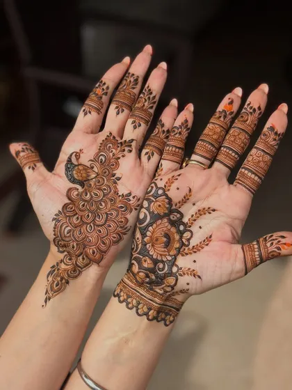 An artistic and asymmetrical design, with a detailed peacock on one hand and a floral bouquet on the other. Perfect for someone who wants a unique look.