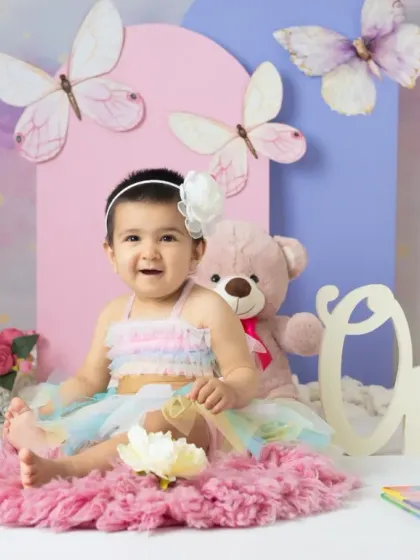 A magical unicorn and butterfly theme for a first birthday. The pastel colors, whimsical props, and dreamy backdrop create a true fairy tale setting.