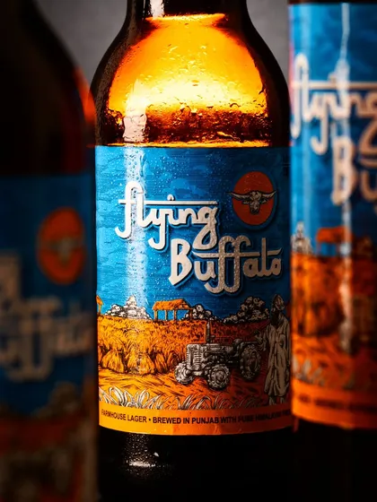 Capturing the perfect beverage shot is a technical art. For Flying Buffalo, I used specific lighting to highlight the beer's beautiful amber color and glycerin to create those perfect, lasting droplets, making the drink look incredibly refreshing.