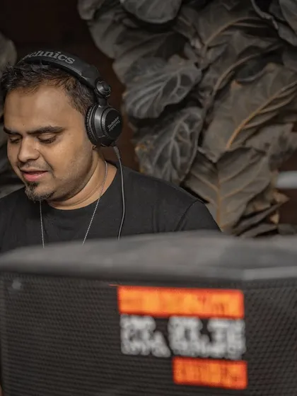 A close-up of me focused on the mix, framed by the venue's decor.