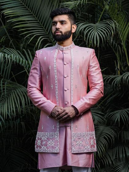 A full-length view of the impeccably tailored pink silk Indo-Western outfit. The clean lines and luxurious fabric create a look that is both modern and timeless.