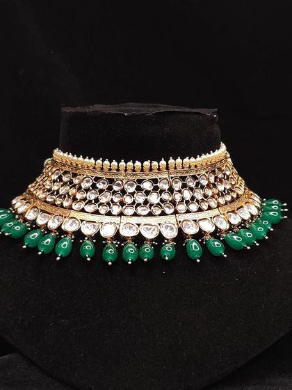 This wide Kundan choker with two layers of Polki stones and green beads is perfect for a bride who wants a substantial but not overwhelming piece.
