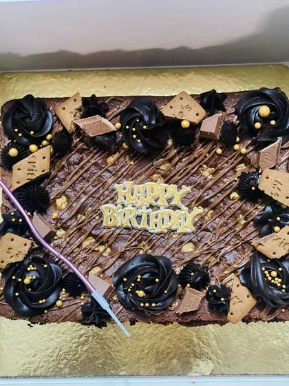Another delicious brownie cake, decorated with chocolate rosettes and wafers.