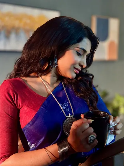 Another angle of the on-set makeup, highlighting the subtle eye makeup and defined brows that complete this polished character look for the television series.