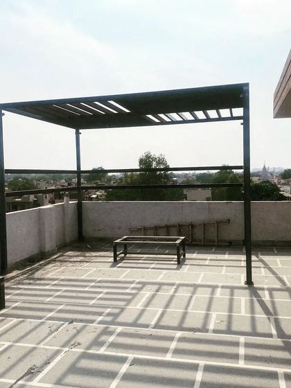 The clean lines of the pergola stand out against the sky.