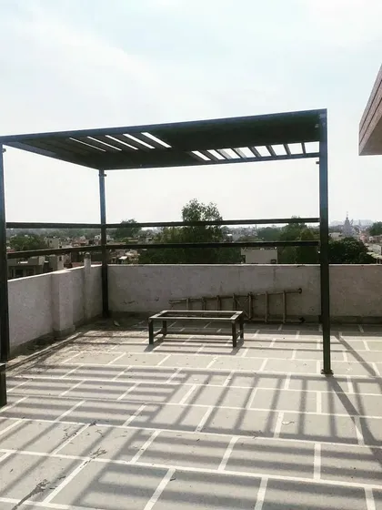 The clean lines of the pergola stand out against the sky.