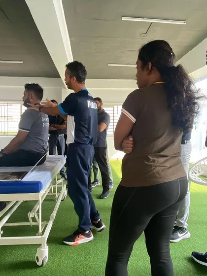During a training session, I'm demonstrating a clinical examination of the cervical spine. Constant hands-on training ensures our team's assessment skills are sharp and accurate.
