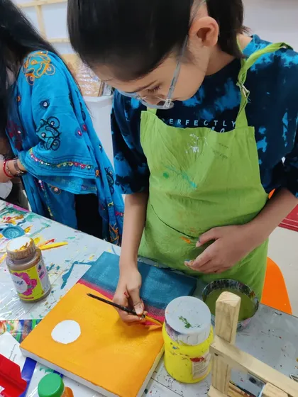 Scenes from our kids' acrylic workshop, where students learn to create bold and colorful landscape paintings.