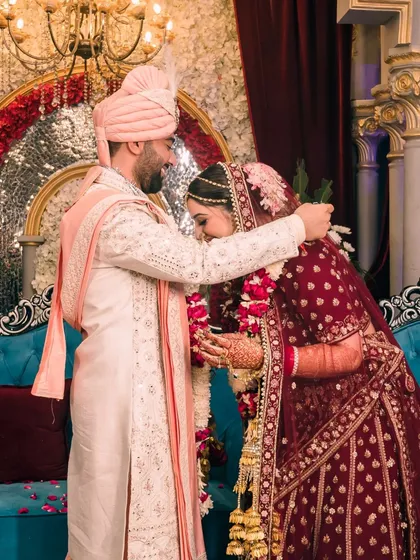 A tender hug following the varmala exchange, this photo shows the couple's deep connection and the emotion of the moment.