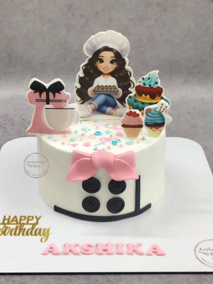 A cute cake for a baker. This design features a chef avatar, a stand mixer, and a stack of colorful cupcakes.