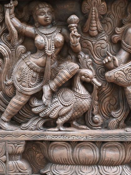 A close-up of an Apsara with a swan from the same panel, showcasing the fine details from her jewelry to the feathers of the bird. Each element is carefully carved to contribute to the overall narrative.