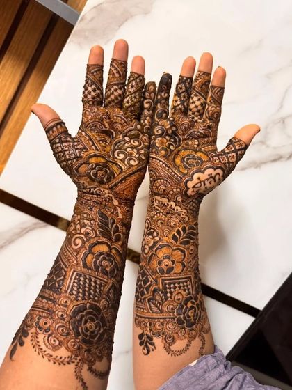A beautiful bridal henna design with a mix of florals, checks, and paisleys. The details are sharp and the coverage is perfect for a bride.