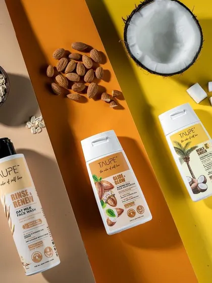 A top-down flat lay for Taupe's skincare line, showcasing the products alongside their natural ingredients like oats, almonds, and coconut. This visual strategy clearly communicates the brand's commitment to natural formulations.