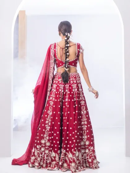 The back of this red bridal lehenga is as stunning as the front. The detailed embroidery and elegant tie-up design ensure you look flawless from every angle on your special day.