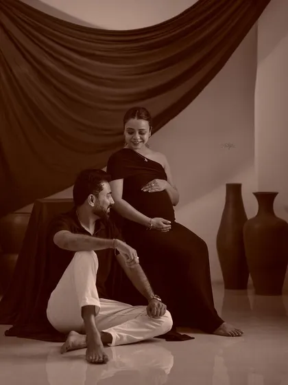 A classic sepia-toned couple's portrait. This timeless editing style adds a warm, nostalgic feel to the maternity photo.