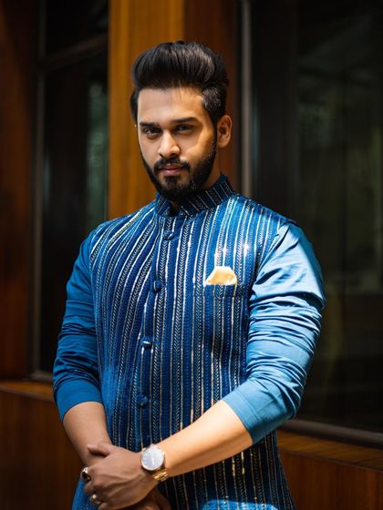 A portrait of the client, highlighting how the bold color and sharp fit of the outfit complement his personal style.