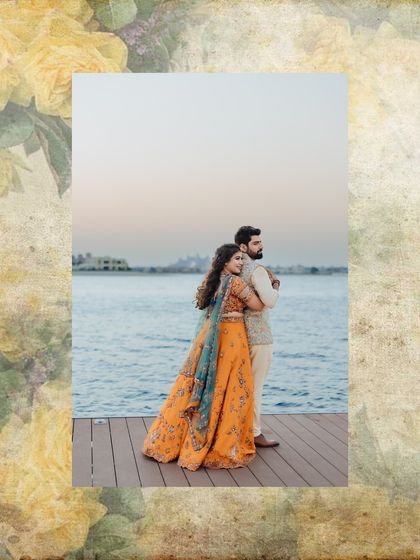 An elegant portrait of a couple on a pier, framed by a vintage floral border.