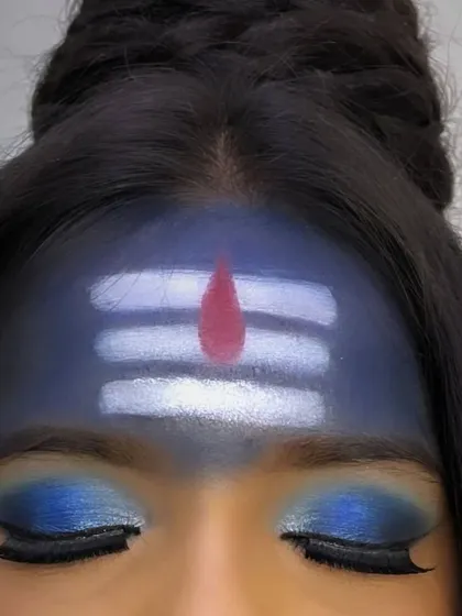 A close-up on a different Mahashivratri inspirational look, focusing on the bold blue eyeshadow and the clean, precise lines of the Tripundra on the forehead.