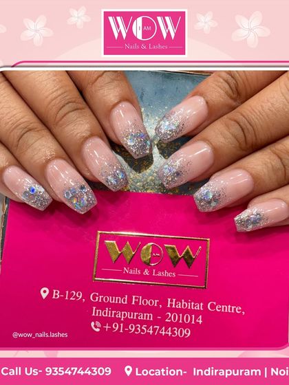 These square-shaped extensions are all about the sparkle. Featuring a sheer nude base with a heavy application of chunky silver glitter at the tips, this is a fun and glamorous look.