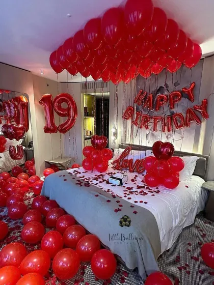 A classic for a reason. This romantic birthday room makeover features a sea of red balloons, rose petals, and bold foil letters to make your loved one feel truly special. It's a full sensory experience of love and celebration.
