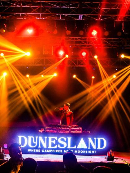 The stage at Dunesland lit up with a spectacular display of orange and yellow lights. My sets are always complemented by a professional and dynamic light show.